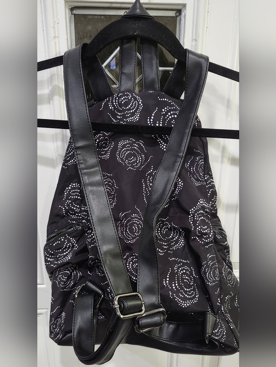 Fabletics The Row Backpack in black with a white digital roses pattern. 